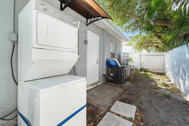 exterior space with stacked washer and dryer and laundry area