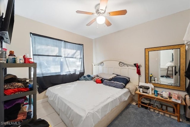 bedroom with light tile patterned floors and a ceiling fan