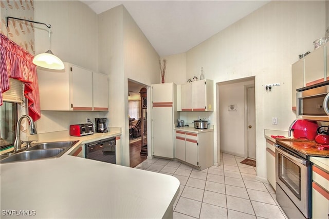 kitchen featuring light tile patterned floors, hanging light fixtures, stainless steel appliances, light countertops, and a sink