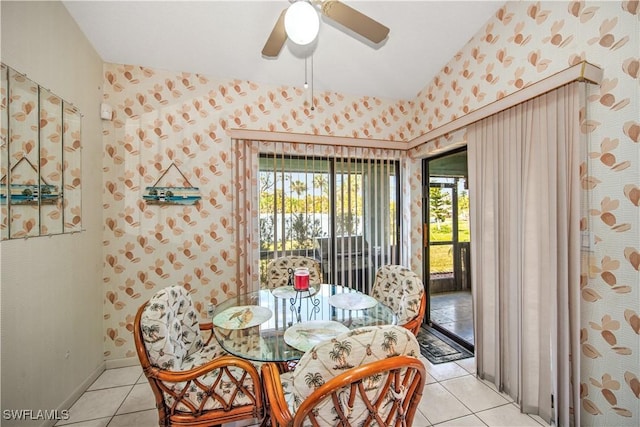 dining area with light tile patterned floors, baseboards, a ceiling fan, and wallpapered walls