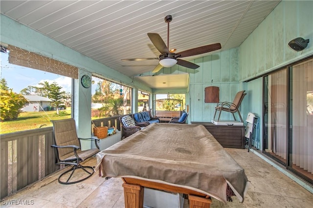 sunroom featuring a ceiling fan