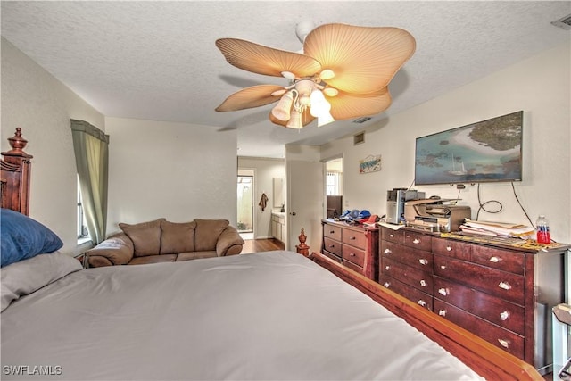 bedroom featuring connected bathroom, ceiling fan, a textured ceiling, and wood finished floors