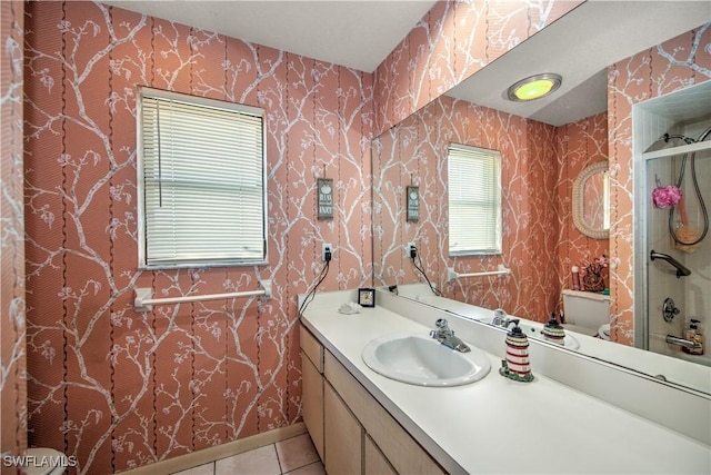 bathroom with toilet, vanity, tile patterned flooring, walk in shower, and wallpapered walls