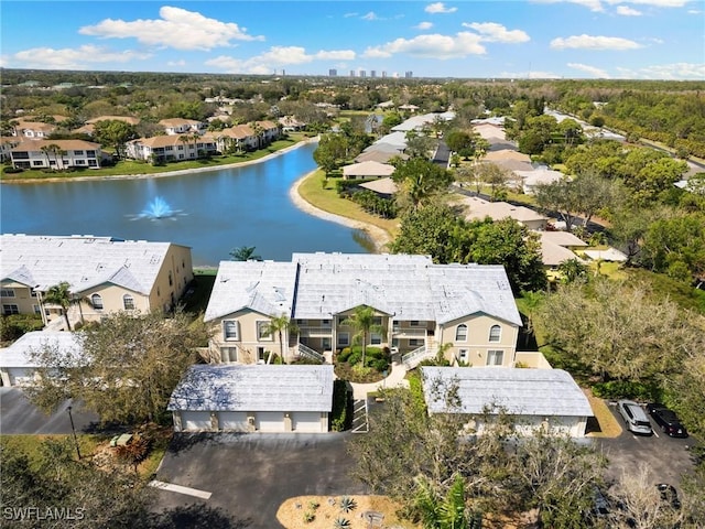 birds eye view of property with a water view and a residential view