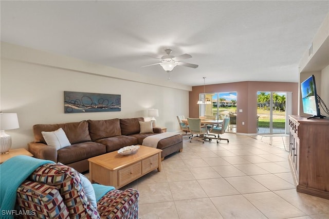 living room with light tile patterned flooring, ceiling fan, and visible vents