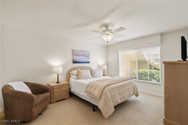 bedroom with baseboards, a ceiling fan, and light colored carpet