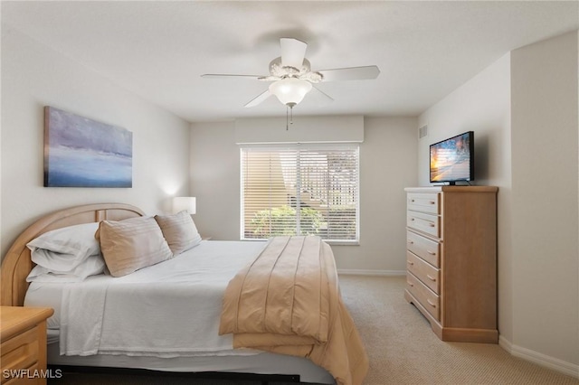 bedroom with baseboards, a ceiling fan, and light colored carpet