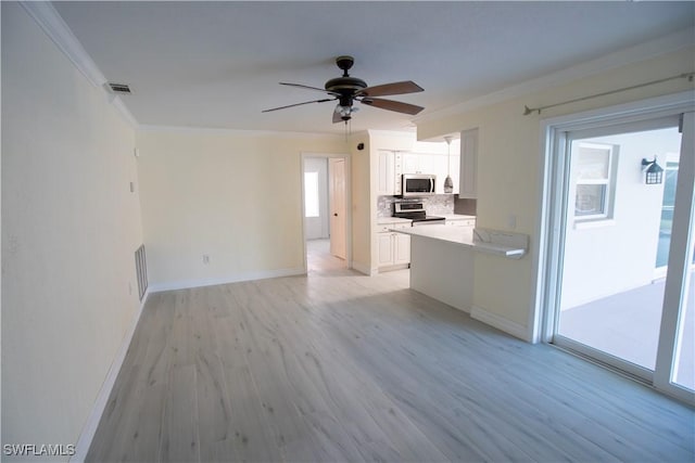 kitchen featuring stainless steel appliances, white cabinetry, visible vents, backsplash, and crown molding