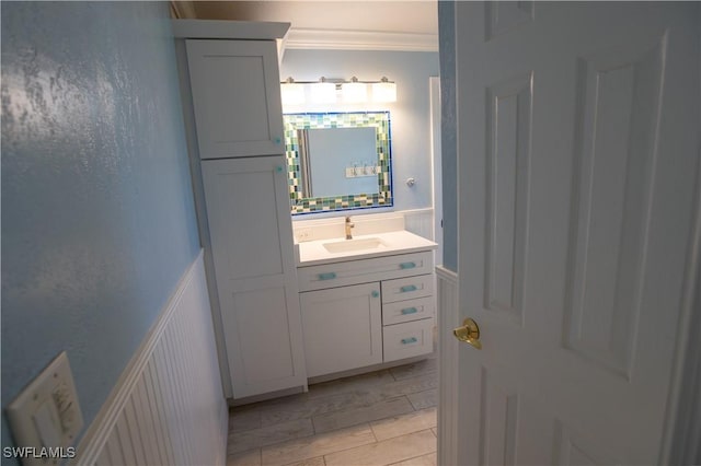 bathroom featuring ornamental molding and vanity