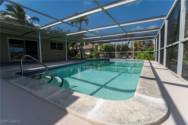 pool featuring glass enclosure and a patio