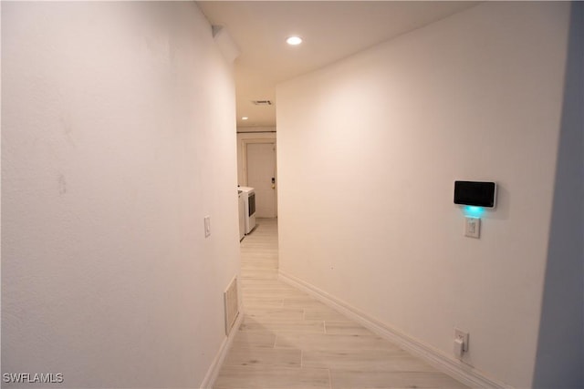 corridor featuring visible vents, recessed lighting, light wood-style flooring, and baseboards