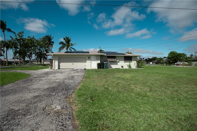 ranch-style house featuring aphalt driveway, a garage, solar panels, stucco siding, and a front lawn