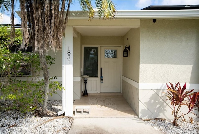 view of exterior entry featuring stucco siding