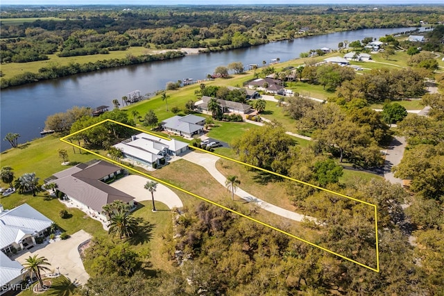 1261 Riverbend Dr, Labelle, FL 33935 - aerial view of residential area featuring a large body of water and property parcel outlined