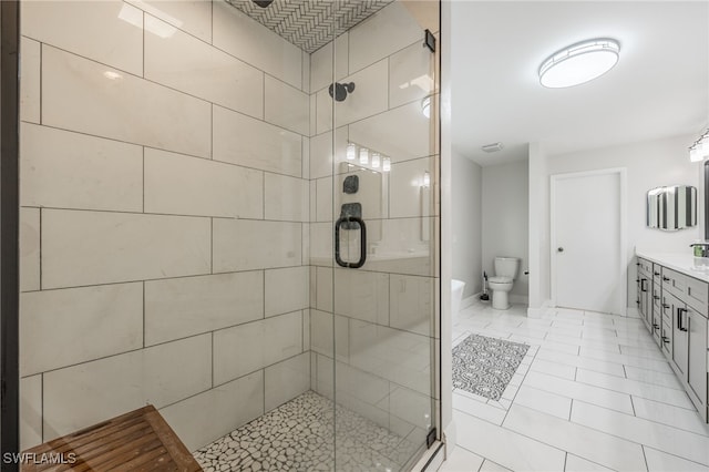 bathroom with toilet, a shower stall, and vanity