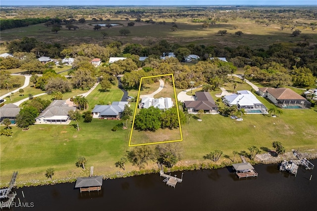 bird's eye view featuring a residential view and a water view