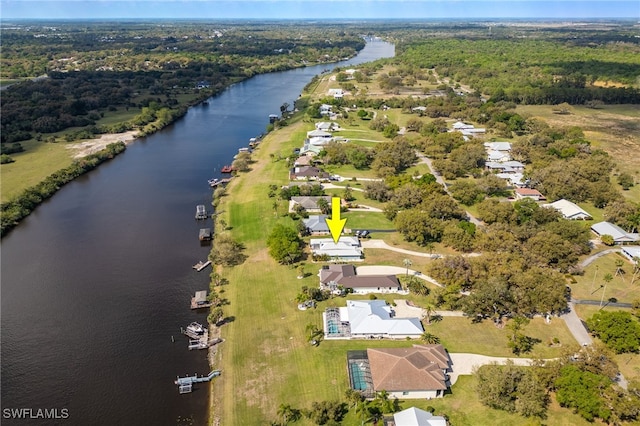 1261 Riverbend Dr, Labelle, FL 33935 - aerial overview of property's location featuring a nearby body of water and a forest