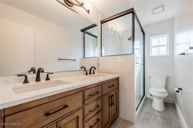 bathroom featuring double vanity, a sink, toilet, and a shower stall