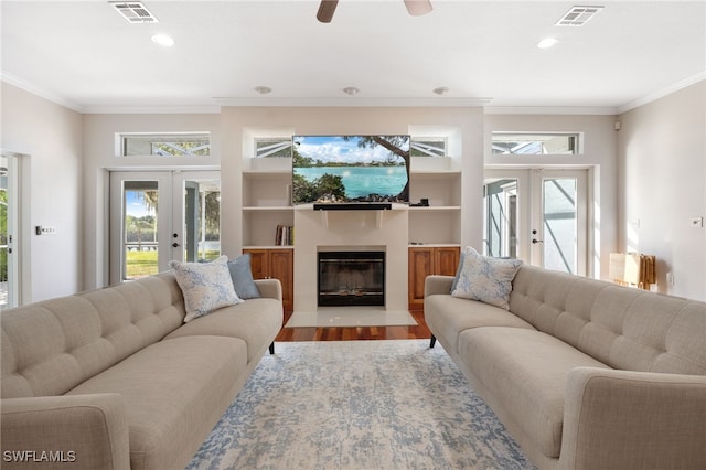 living room featuring ornamental molding, french doors, wood finished floors, and visible vents