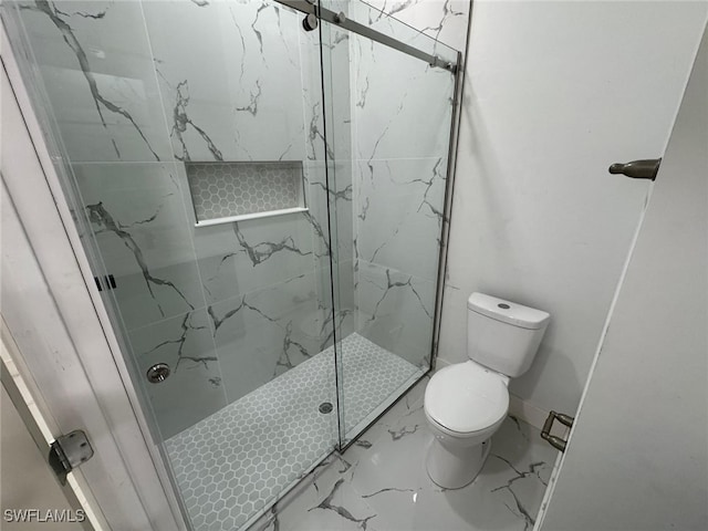 bathroom featuring marble finish floor, baseboards, toilet, and a marble finish shower