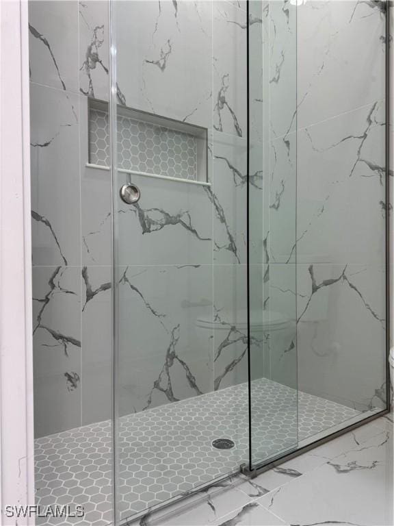 bathroom featuring a shower stall