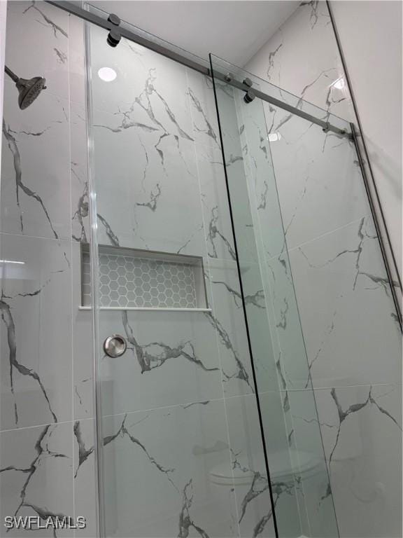 full bath featuring a marble finish shower