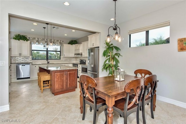 dining space with baseboards, recessed lighting, visible vents, and a healthy amount of sunlight