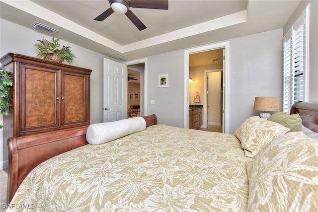 bedroom with a ceiling fan, a raised ceiling, and visible vents