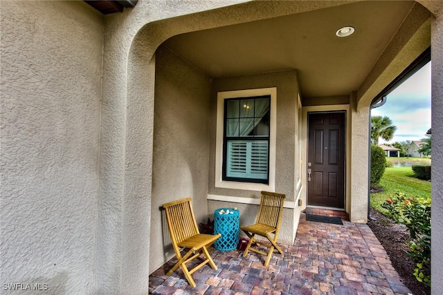 property entrance with stucco siding