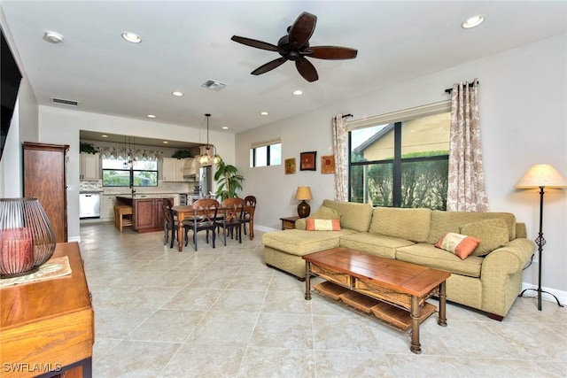 living room with baseboards, visible vents, a ceiling fan, and recessed lighting