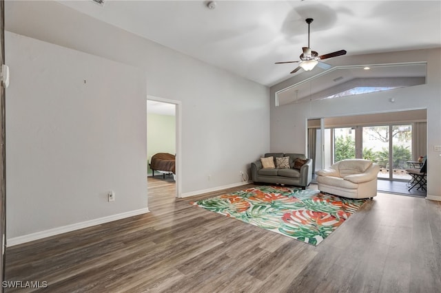 living room with lofted ceiling, ceiling fan, wood finished floors, and baseboards