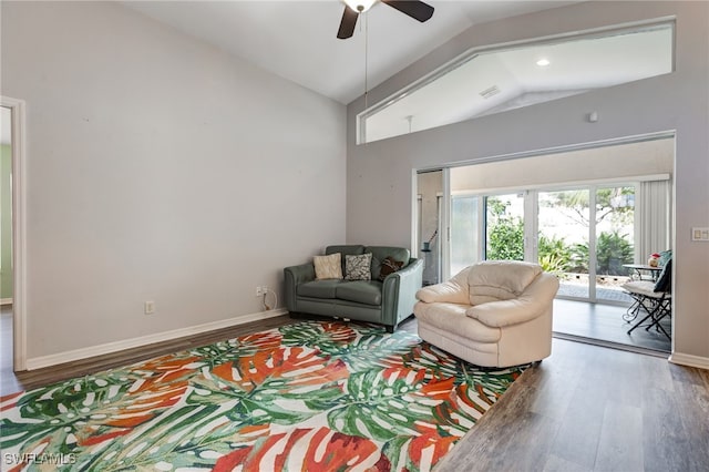 living room featuring vaulted ceiling, wood finished floors, visible vents, and baseboards