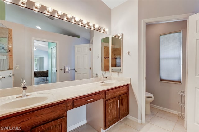 full bathroom featuring double vanity, ensuite bath, tile patterned flooring, and a sink