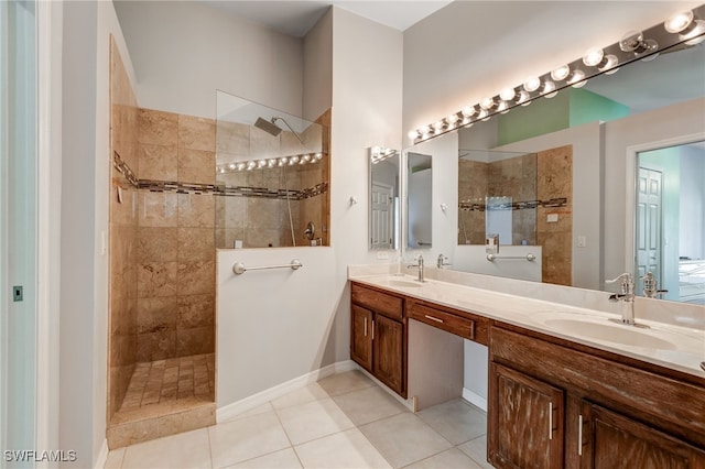 bathroom with double vanity, tile patterned flooring, walk in shower, and a sink