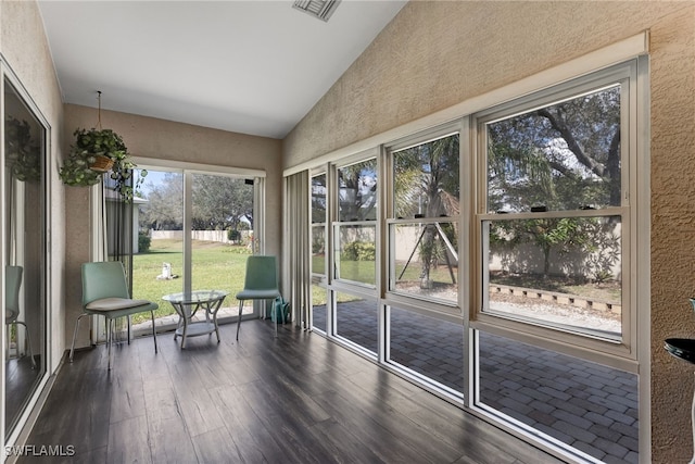 unfurnished sunroom featuring vaulted ceiling and visible vents