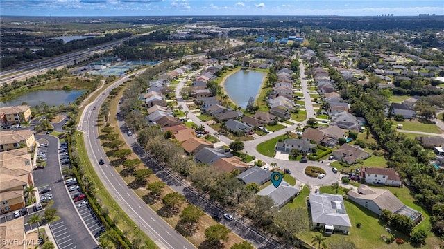 drone / aerial view with a residential view and a water view