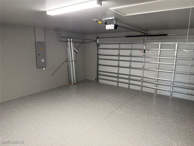 garage with electric panel and a garage door opener