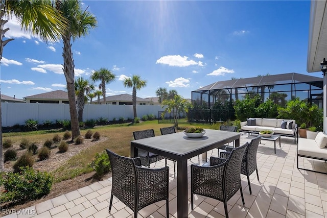 view of patio / terrace featuring outdoor dining area, a fenced backyard, a lanai, and an outdoor living space