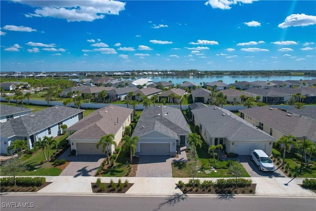 birds eye view of property with a residential view and a water view