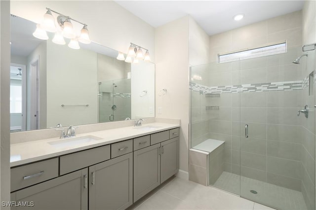 full bath featuring a stall shower, tile patterned flooring, a sink, and double vanity