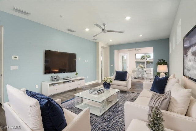 living room with dark wood-style floors, a ceiling fan, visible vents, and recessed lighting