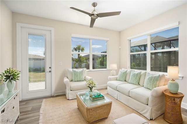 sunroom featuring a healthy amount of sunlight and a ceiling fan