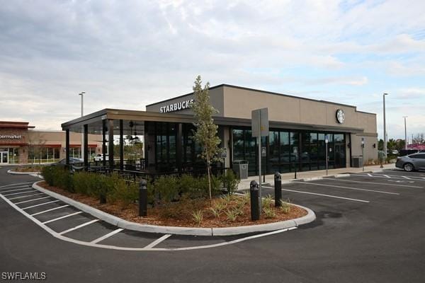 view of building exterior with uncovered parking