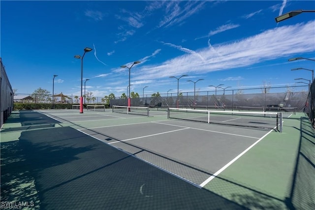 view of tennis court with fence