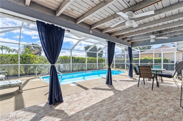 view of pool featuring ceiling fan, glass enclosure, a patio area, and a fenced in pool