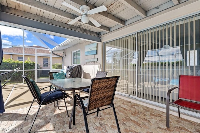 sunroom / solarium with a ceiling fan, beam ceiling, and wooden ceiling