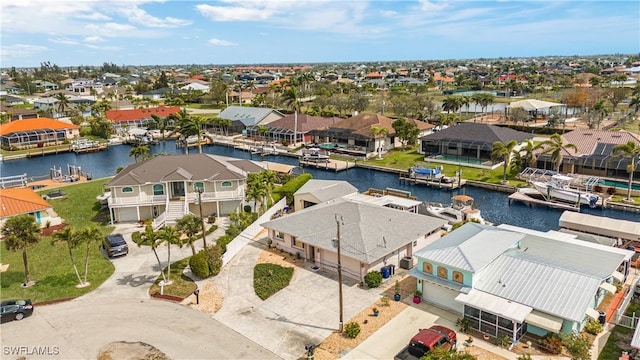 drone / aerial view with a residential view and a water view