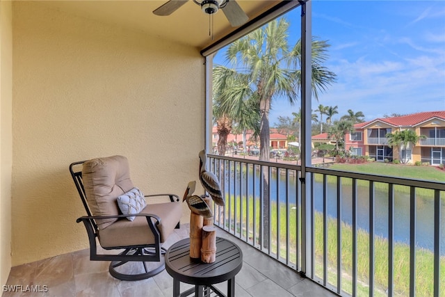 balcony featuring ceiling fan, a water view, and a residential view