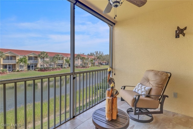 balcony featuring a ceiling fan, a residential view, and a water view