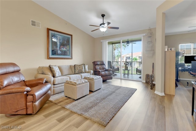 living room featuring light wood-style floors, lofted ceiling, visible vents, and a ceiling fan